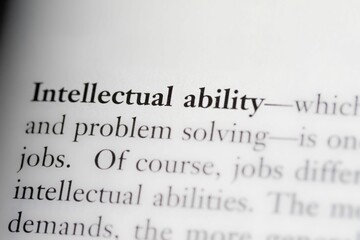 Close-up of a business textbook with the term 'intellectual ability' highlighted and focused
