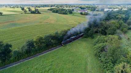 smoke is coming out from a train engine in an open area
