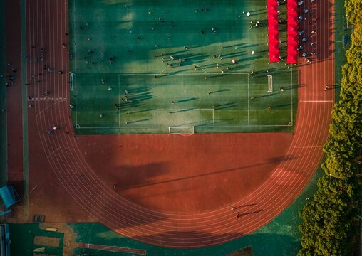Aerial view of a large running track surrounded with lush greenery