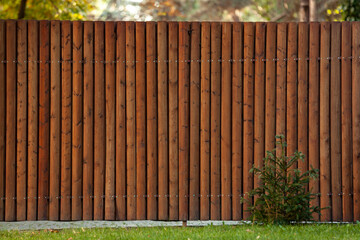 Fence made from scrap wood. Waste-free use of timber. Eco friendly wooden background.