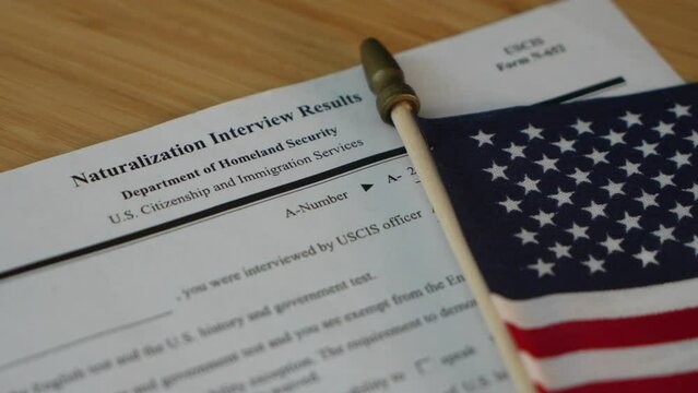 Naturalization interview results, USCIS form N - 652 Next to the flag of USA