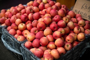 Vibrant farmers market featuring a pile of fresh apples on display