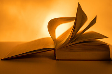 In backlighting, the pages of a large book are turned up close to the front to emphasise the...