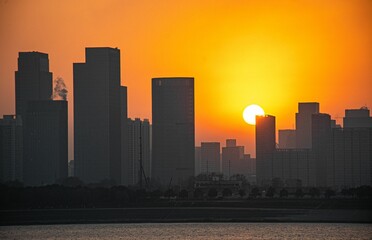 Fototapeta premium Stunning aerial view of a bustling metropolitan cityscape bathed in the warm glow of the sunset