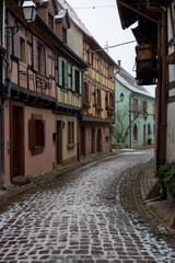 Fototapeta na wymiar Charming Street with Old Houses in Beautiful village Eguisheim, in christmas time, Alsace, France