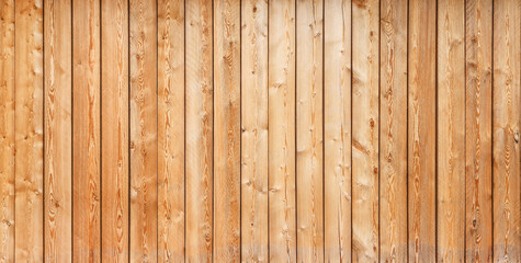 Texture of the pale orange wall made of knotty sanded wooden boards as a retro natural background