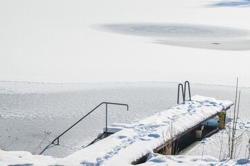 Landscape view of the frozen beach and snow-capped pier