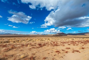 Fototapeta na wymiar Landscape of Dramatic Clouds Desert Mountains in Nevada with blue sky on the horizon