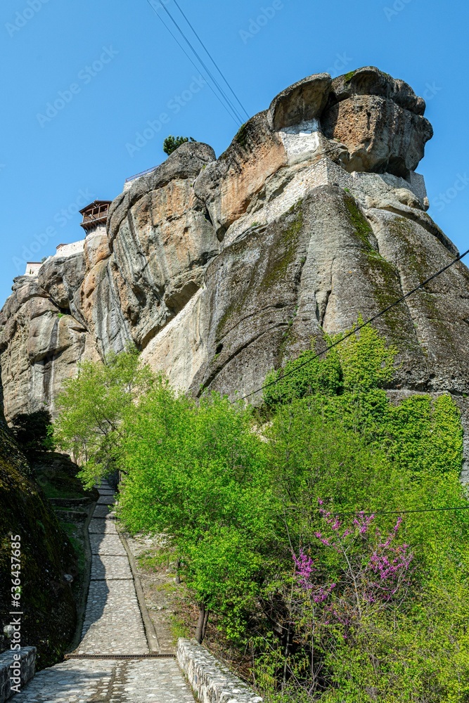 Poster rock formations in the distance with a path that goes to a large rock formation
