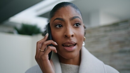 Serious woman talking phone closeup. Worried african american discuss business