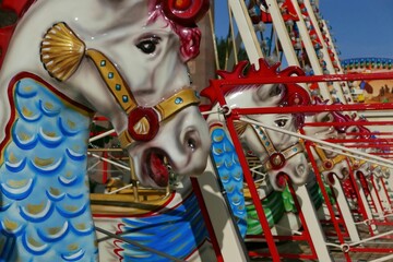 Traditional carousel with bright-colored horses in a cheerful atmosphere
