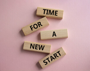 Time for a new start symbol. Wooden blocks with words Time for a new start. Beautiful pink background. Business and Time for a new start concept. Copy space.