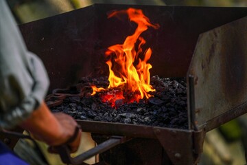 Closeup shot of a grill with burnt coal and flames