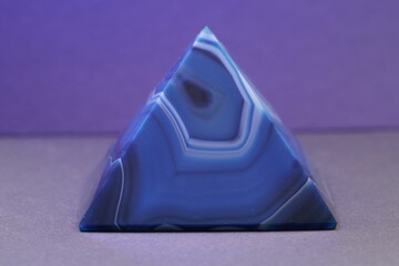 Closeup shot of a violet pyramid of agate with quartz inclusions