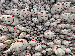 Maneki neko Japanese traditional buddhist lucky cat at Gotokuji Temple Tokyo. 