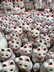 Maneki neko Japanese traditional buddhist lucky cat at Gotokuji Temple Tokyo. 