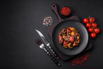 Delicious juicy fresh salad of baked eggplant, tomatoes, sweet peppers, sesame seeds