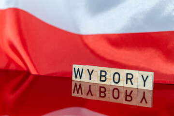 Elections in Poland year 2023, Concept, White and red national banner encouraging to go to vote in parliamentary elections. the word WYBORY in Polish meaning Elections in English. - obrazy, fototapety, plakaty