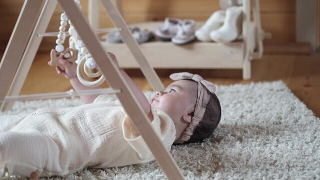 radiant little girl playfully reaches for her wooden Montessori toys, exemplifying the method's principles of self-directed, hands-on learning. Early Development Milestones. The Magic of Montessori