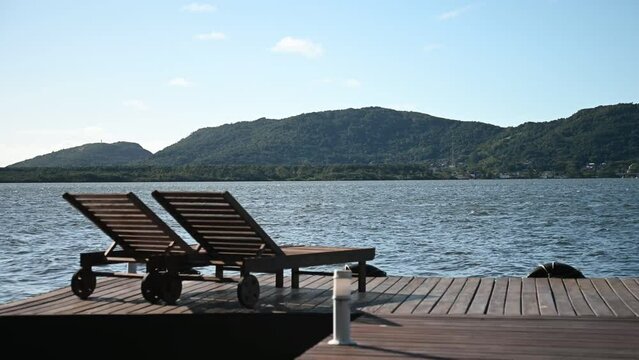 Wooden chair on a beautiful deck to relax by the lagoon