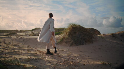 Calm woman spinning beach in sunlight. Lonely black hair girl admire enjoy sand