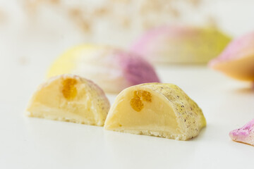 Set of homemade chocolate bonbons slice. Assortment of hand painted candies. Candy cut in a half. Mockup with a copy space. Macro shot of  chocolatier products on white background