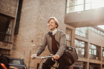 Middle aged caucasian man riding a bicycle and commuting to work