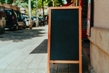 Blank cafe menu board on the street of a European city