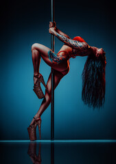 Young sexy brunette woman pole dancing, tattoo on body - 636456847