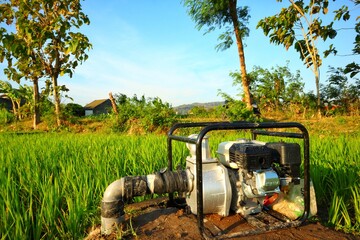 Irrigation water pump machine, on rice farming land, in rural Sleman, Yogyakarta.