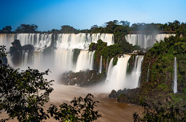 Fototapeta premium Iguazu Falls at Isla San Martin, one of the new seven natural wonders of the world in all its beauty viewed from the Argentinian side - traveling and exploring South America 