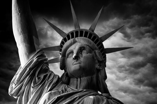 Black and white photo of the Statue of Liberty close-up against a cloudy sky.