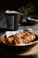Traditional colombian food, Tequeño or Baked Cheese Stick on a brown plate and black napkin served on a dark table with hot chocolate drink, Dark food lighting