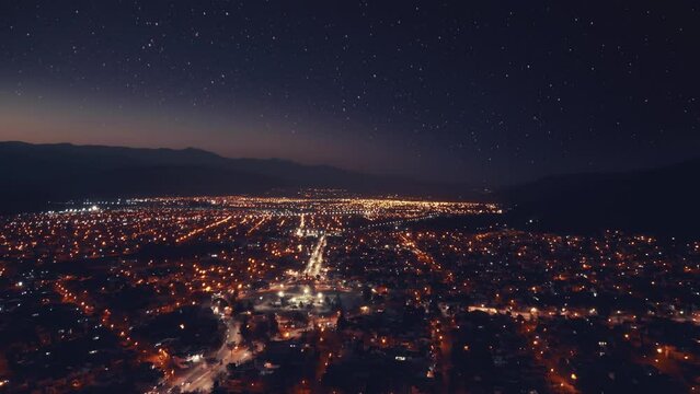 Aerial drone flying over night Salta city in Argetntina. Sunset. City night lights.
