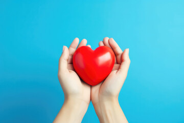 Fototapeta premium Medical Professional Tenderly Holding Heart on Blue