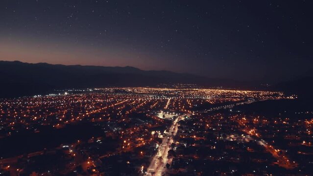 Aerial drone flying over night Salta city in Argetntina. Sunset. City night lights.