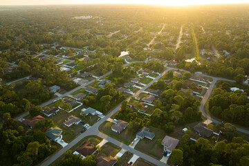 Aerial view of suburban landscape with private homes between green palm trees in Florida quiet...