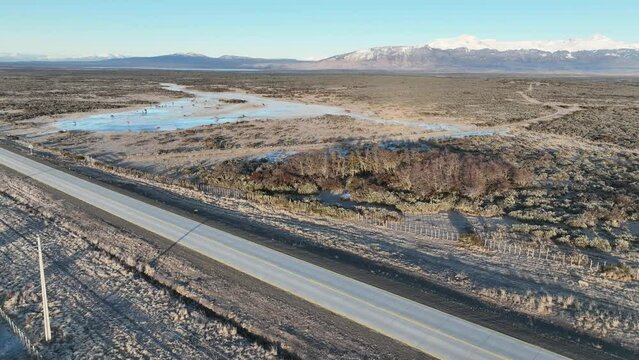 Patagonia Road At Puerto Natales In Ultima Esperanza Chile. Snowy Mountains. Road Landscape. Ultima Esperanza Chile. Winter Background. Patagonia Road At Puerto Natales In Ultima Esperanza Chile.