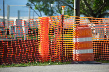 Protective restriction barrier at industrial construction site. Safety mesh fence for pedestrians