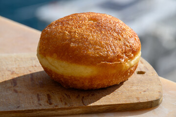 Fried in oil french stuffed with apples or chocolate beignets donuts pastry, sweet dessert served outdoor
