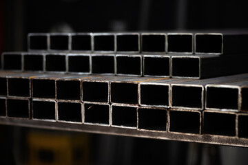 stack​ of square​ steel tubes​ profile or pipes for construction supplies and welding works