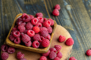 Ripe raspberries on a wooden board