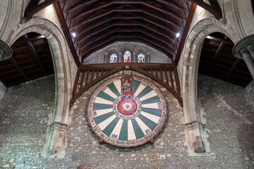 The medieval Round Table of King Arthur from the Arthurian legend, hanging on the wall in the Great Hall in Winchester, England, UK.