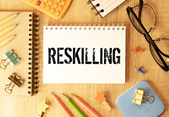 Reskilling text on sticky notes with office desk.