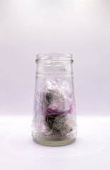 a glass jar of bags of weed 