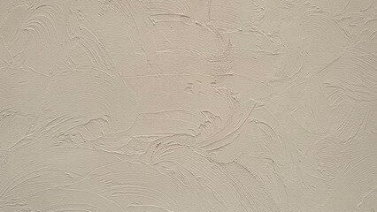 The cream-colored walls are plastered with patterns that flicker like waves