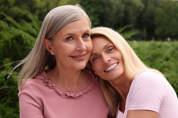Naklejka premium Happy mature mother and her daughter outdoors