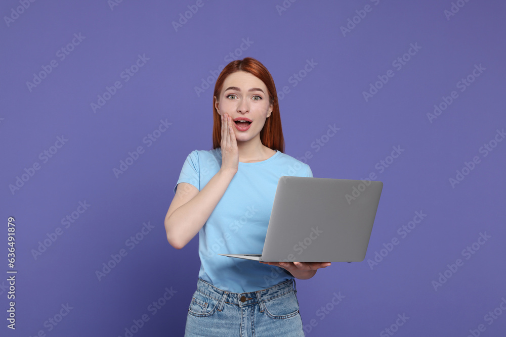 Canvas Prints Surprised young woman with laptop on lilac background