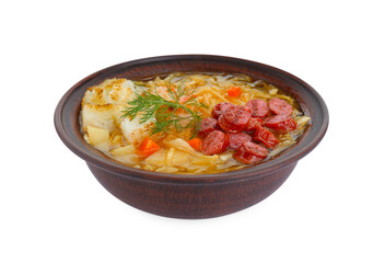 Bowl of delicious sauerkraut soup with smoked sausages, dill and croutons isolated on white