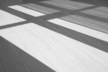 Shadow from window on white laminated floor